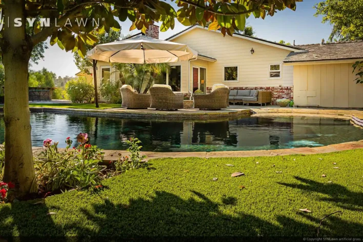 image of environmentally friendly backyard pool surround using synthetic grass