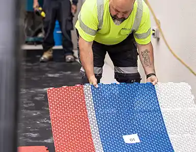 image of man installing syn court sports tile system
