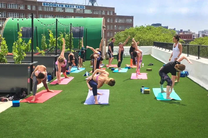 Rooftop yoga class on SYNLawn artificial turf at the Brooklyn Navy Yard in Brooklyn, New York